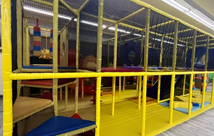 Multi-level yellow and blue play structure for kids at Willits Kids Corner in Willits, CA